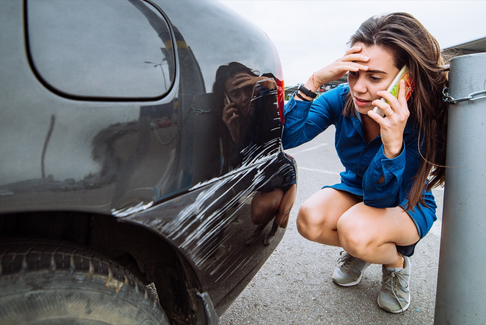 Women looking at her damaged car